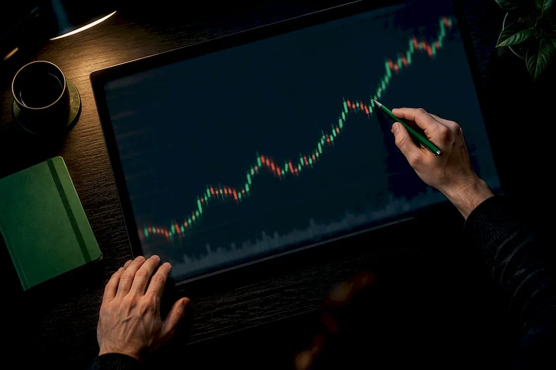 Hands tracing a forex trend chart